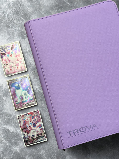 Purple card binder with 'TROVA' branding on a gray surface with trading cards.